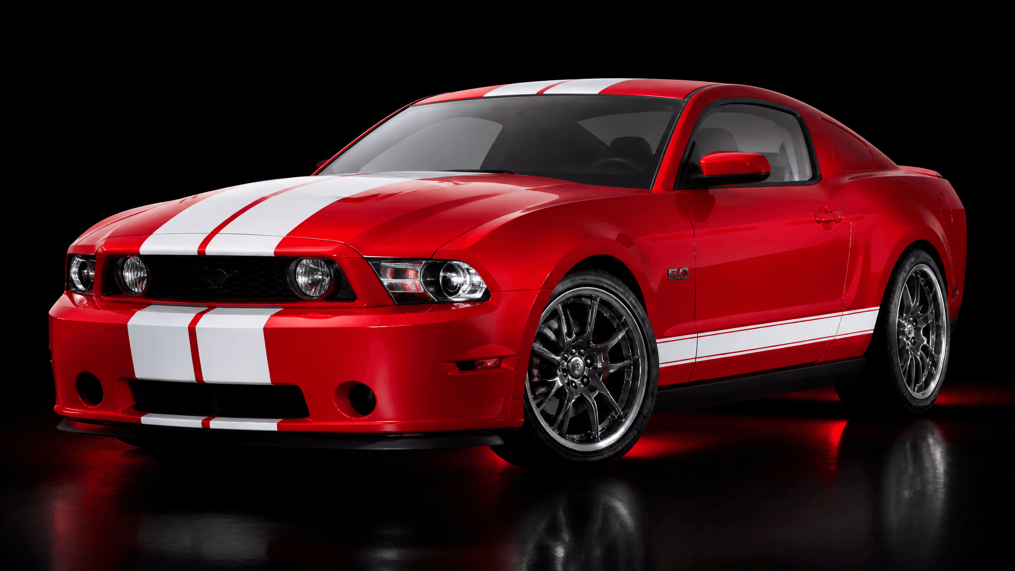 Red Ford Mustang GT with white racing stripes